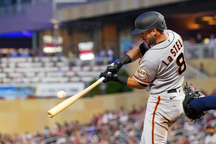 SF Giants infielder Tommy La Stella hits a sacrifice fly against the Twins.